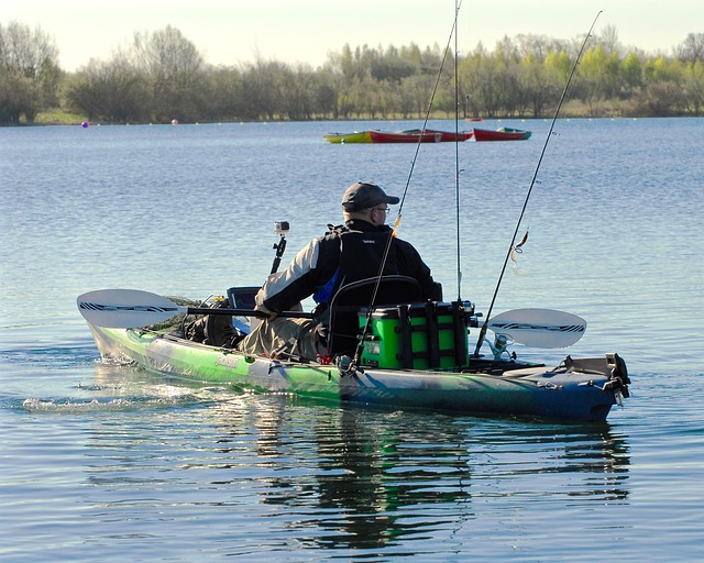 Angler standing and casting from a fishing kayak